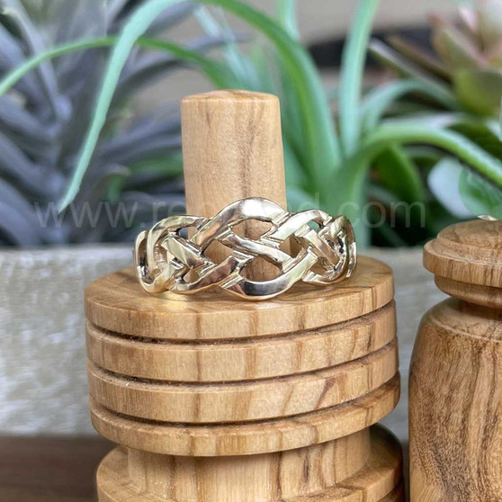 The Elidir Knot Ring features intricate pierced knotwork. Shown in yellow gold.