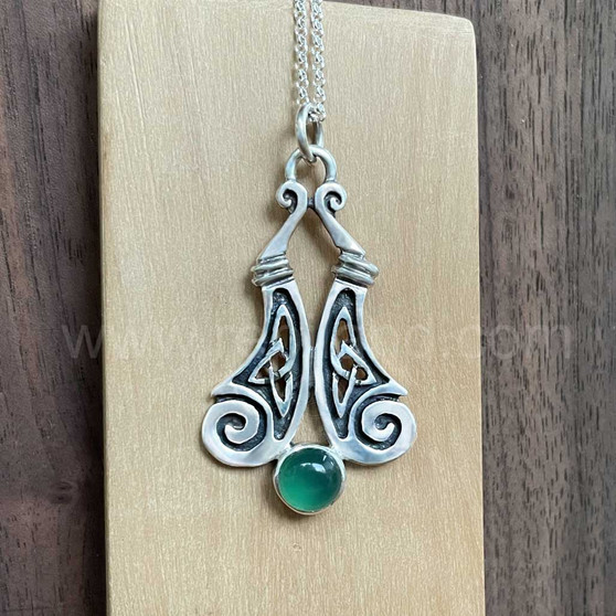 The Boreray Gem Pendant features curving pieces with elongated trinity knots and spiraled ends above an 8mm gemstone. Shown with Green Agate.