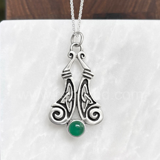 The Boreray Gem Pendant features curving pieces with elongated trinity knots and spiraled ends above an 8mm gemstone. Shown with Green Agate.
