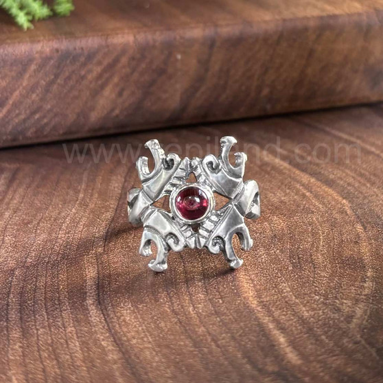 The Beithir Gem Ring has 4 stylized serpent dragon heads surrounding a 6mm gemstone. Shown with Garnet.