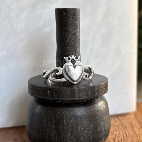The Grá mo Chroí Claddagh Ring features a solid raised heart within a heart, a delicate crown and graceful open knotwork sides.