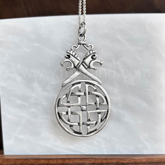 The Vorthr Knot Pendant has stylized serpent dragon heads above a large circular shield knot.