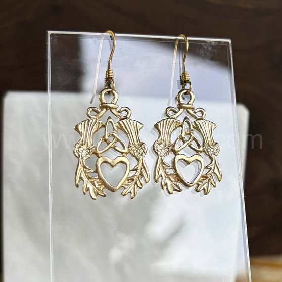 The Mìn Earrings features thistles, leaves, a trinity knot and a heart. Shown in yellow gold.
