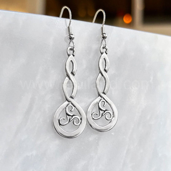 The Grian Triskele Earrings feature a graceful twist drop with a triskele.