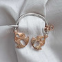 The Eige Penannular features stylized double thistles. Shown in sterling and 14kt rose gold.