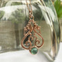 Môr Draig Gem Pendant, dragons with curls and beads above an 8mm gemstone. Rose gold.