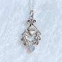 The Flora Gem Pendant features curving oak leaves, a capped acorn and 6mm gemstone. Shown with Blue Topaz.