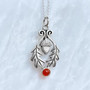 The Flora Gem Pendant features curving oak leaves, a capped acorn and 6mm gemstone. Shown with Cornelian.