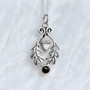 The Flora Gem Pendant features curving oak leaves, a capped acorn and 6mm gemstone. Shown with Onyx.