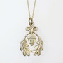 The Grizel Pendant features a capped acorn framed with oak leaves. Shown in yellow gold.