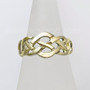 The Elidir Knot Ring features intricate pierced knotwork. Shown in yellow gold.