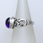 The Elidir Gem Ring features intricate, pierced knotwork with an 8x10mm gemstone. Side view.