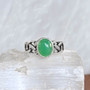 The Elidir Gem Ring features intricate, pierced knotwork with an 8x10mm gemstone. Pictured with Chrysoprase.