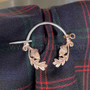 The Arran Penannular features an acorn & oak leaf on each end. Shown in sterling & rose gold on Clan Home Tartan.