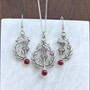 The Cirsium Gem Earrings with Garnets, shown with the Lyall Gem Pendant, sold separately.