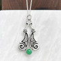 The Boreray Gem Pendant features curving pieces with elongated trinity knots and spiraled ends above an 8mm gemstone. Shown with Chrysoprase.