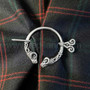The Dunface Penannular has S curve accents and rams head ends. Shown on Clan Hume tartan.