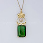 14kt yellow gold pendant with leaves and curls above a 20.71ct Green Tourmaline and accented with a Rainbow Moonstone. 