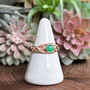 The Hawise Gem Ring features a 6mm gem and pierced curling knotwork. Shown in rose gold with Chrysoprase.