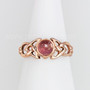The Ribean Gem Ring has a 6mm gemstone, triangular pierced knotwork and a grooved back. Shown in rose gold with Pink Tourmaline.
