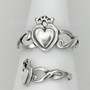 The Grá mo Chroí Claddagh Ring features a solid raised heart within a heart, a delicate crown and graceful open knotwork sides. Shown with side view.