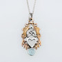 The Lannier Gem Pendant features thistles, leaves, a trinity knot, a heart and a 6mm gem. Pictured in rose gold, sterling and Blue Topaz.