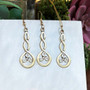The Grian Triskele Earrings in 14kt yellow gold, shown with the matching pendant, sold separately.