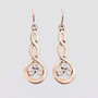 The Grian Triskele Earrings feature a graceful twist drop with a triskele. Shown in 14kt rose gold.