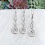 The Grian Triskele Pendant, shown with the matching earrings, sold separately.