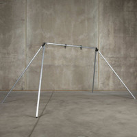 Portable rigid conduit gong stand assembled in open field, showing lightweight steel target frame with AR400 free-spinning mount ready for hanging steel plates.