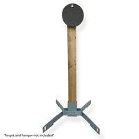 Outdoor shooting setup featuring AR500 round steel target mounted on 2x4 static stand system used for defensive pistol and carbine marksmanship training practice