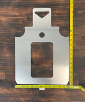 Silhouette target stencil positioned on steel plate with shoulder and center-mass cutouts, marking defensive shooting zones for realistic training scenarios.
