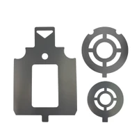 Close-up detail of steel target stencil edges showing cutout measurement guides and tab design used to prevent overspray during target painting.