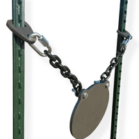 Installed AR500 steel gong target mounted between fence posts in outdoor range setting for long-distance rifle shooting practice and training sessions
