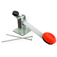Close-up detail of flipper mechanism mounted with 1/2 inch carriage bolt, showing base bracket, hardware, and steel construction components.