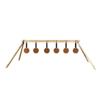 Installed steel plate rack mounted on 2x4 wooden frame at outdoor shooting range, showing multiple reactive targets hanging in training configuration.