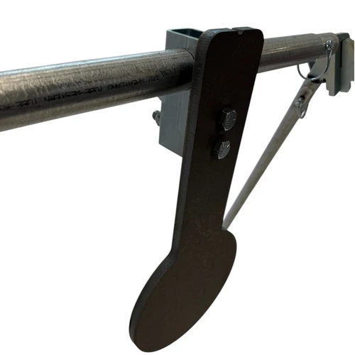 Close-up detail of 1/2-inch AR500 steel spinner plate with CNC laser-cut edges and mounting shaft spacers designed for smooth rotational movement on impact