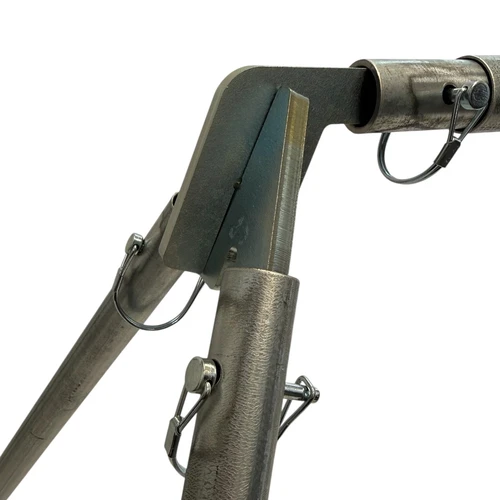 Rifle round impacting steel spinner target at distance, causing visible rotational spin demonstrating accurate shot placement and immediate visual feedback system