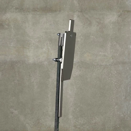 Installed range view showing AR steel target hanging on T-post, with protector plates shielding post from low hits during rifle and pistol training.