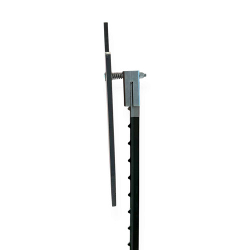 Shooter engaging steel silhouette target mounted on T-post system in open range environment, with plate swinging slightly after impact confirming successful shot placement.