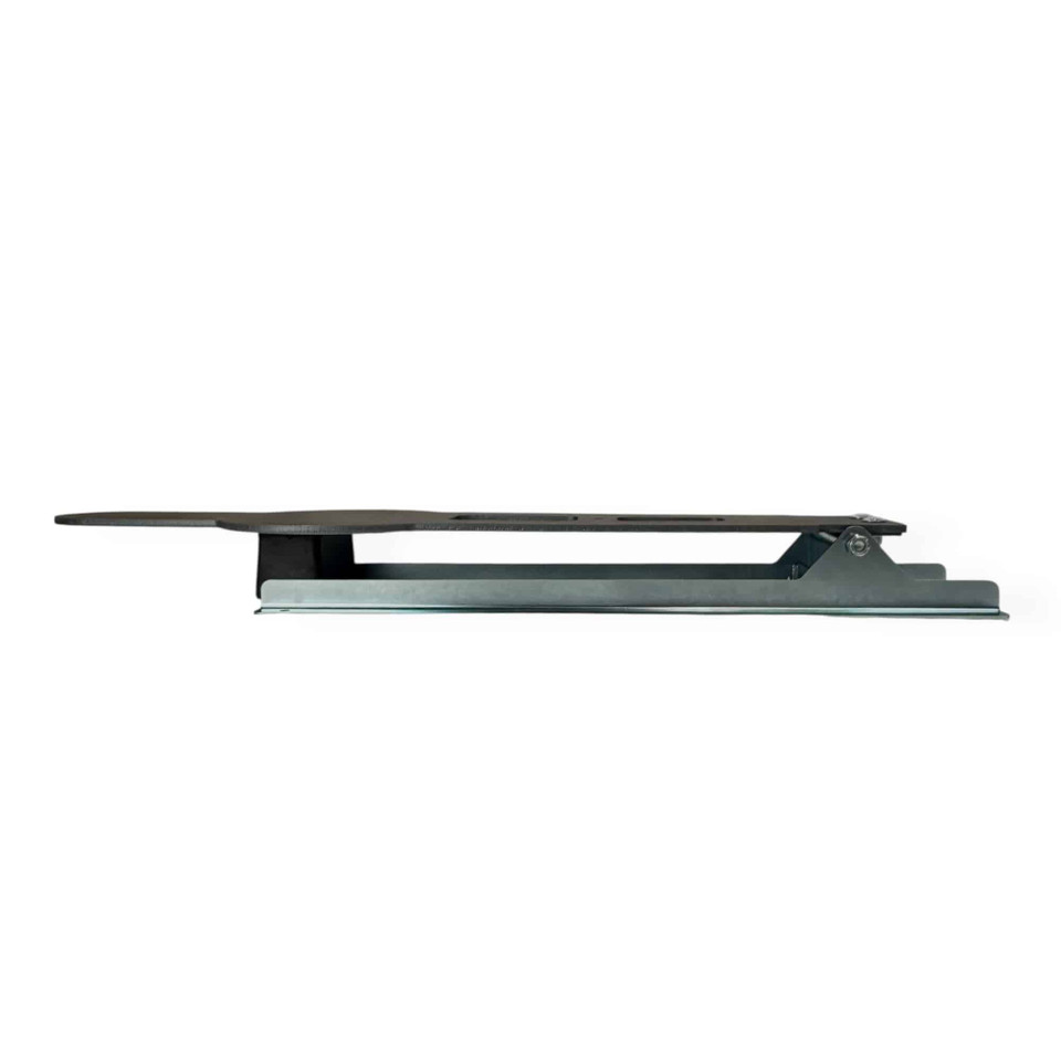 Installed pepper popper base system with zinc-plated steel frame anchored by stakes on uneven terrain for stable outdoor range setup.