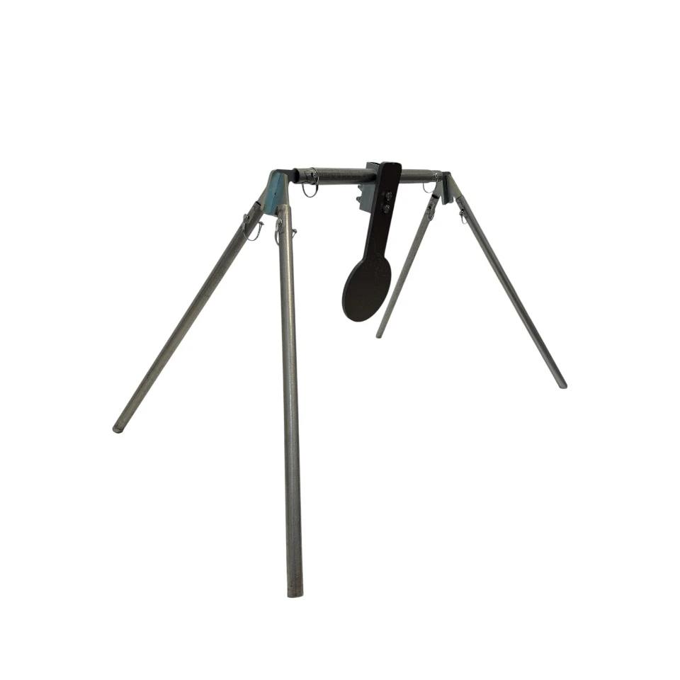 Shooter engaging spinner target setup from prone position in open field range, emphasizing long-distance rifle training environment with stable mounted steel target system