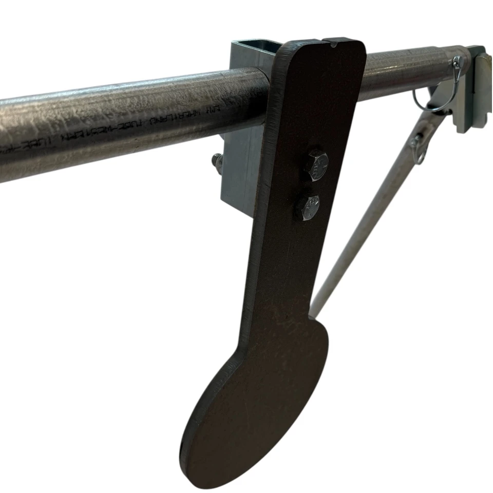 Close-up detail of 1/2-inch AR500 steel spinner plate with CNC laser-cut edges and mounting shaft spacers designed for smooth rotational movement on impact