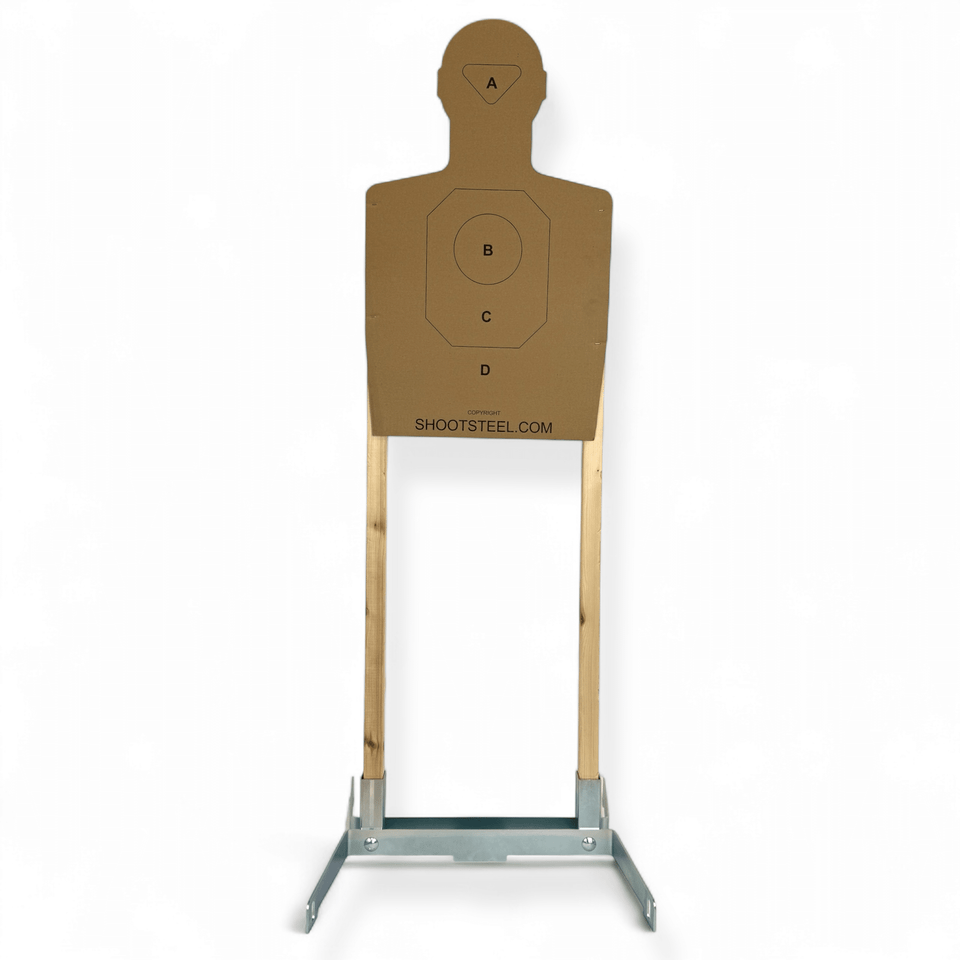 Installed cardboard target stand holding IDPA silhouette backer demonstrating rigid steel base performance during pistol training sessions with minimal movement