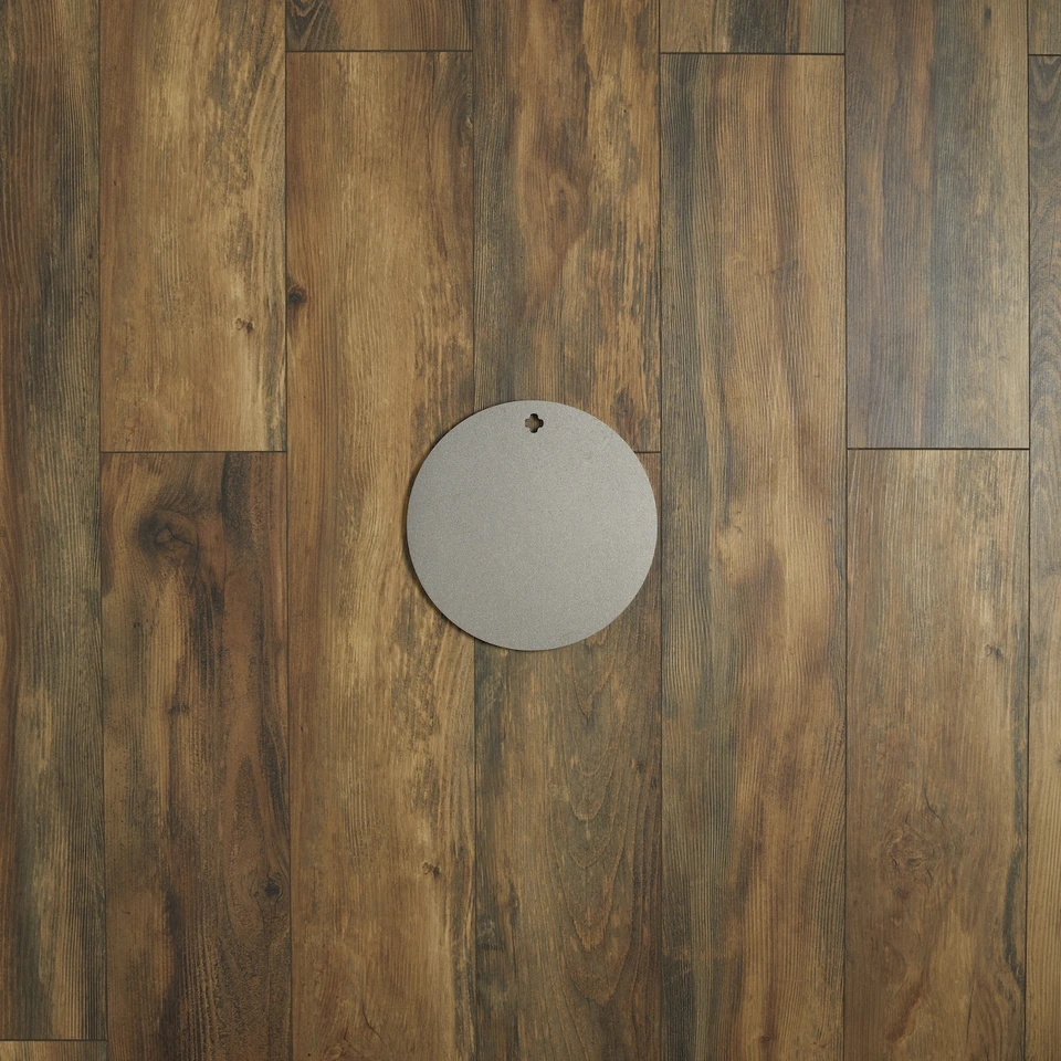 Installed AR500 round steel target hanging from static hanger system demonstrating stable setup for centerfire handgun and rifle training practice session