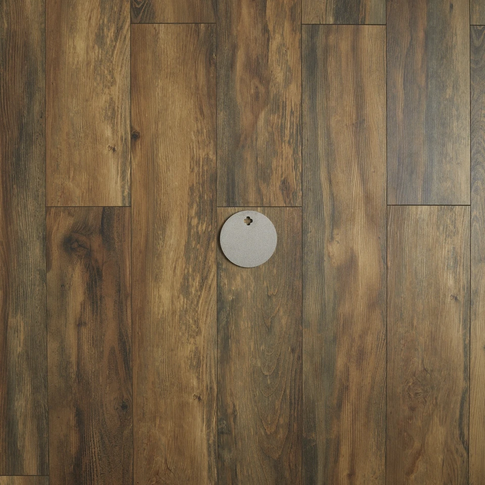 Steel round target absorbing rifle impact on outdoor range with visible ring reaction and minimal movement during centerfire shooting practice session