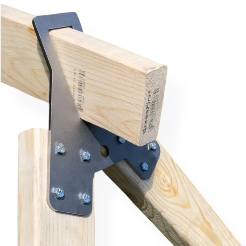Steel target hanging securely from hybrid hanger system with chain attachment, demonstrating tool-free mounting on wooden crossmember structure.
