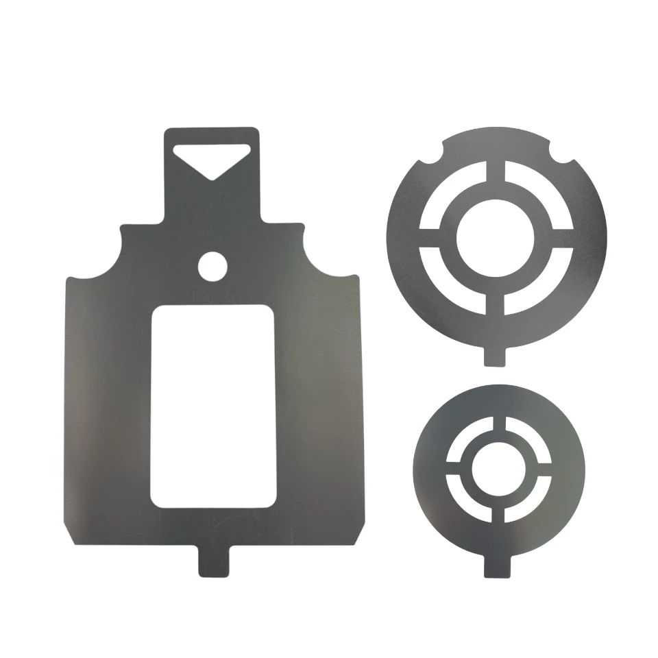 Close-up detail of steel target stencil edges showing cutout measurement guides and tab design used to prevent overspray during target painting.