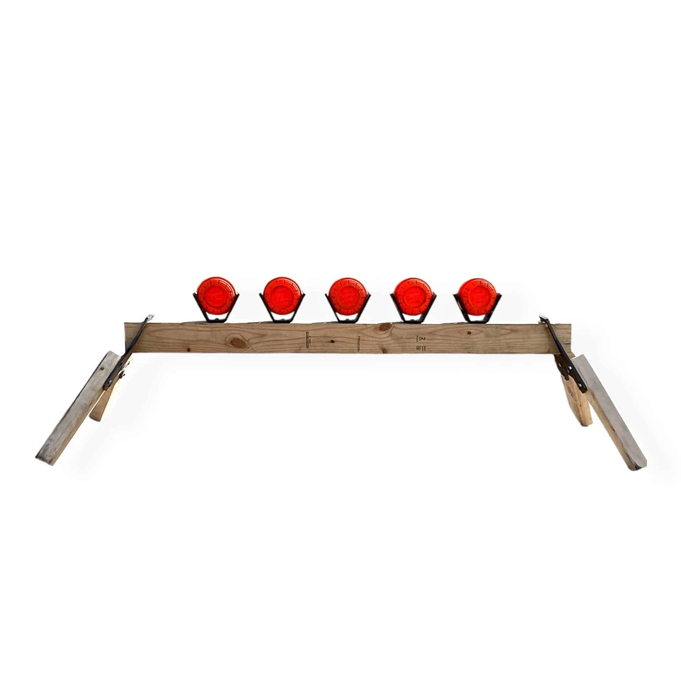 Clay pigeon target breaking on impact during .22 Long Rifle shooting, producing visible dust burst for instant feedback in backyard training setup