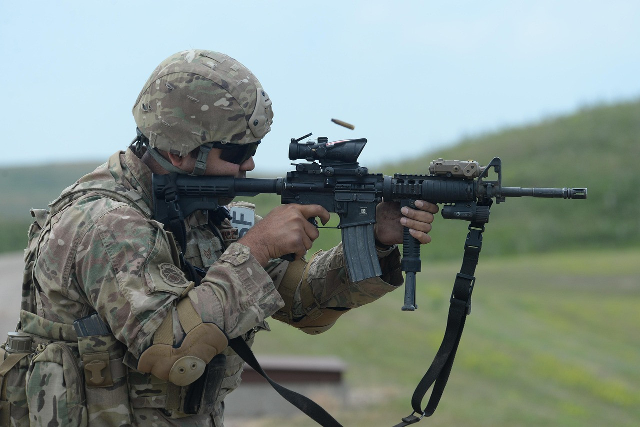 Soldier shooting M4 with accessories